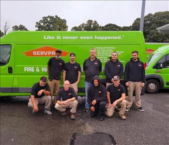 SERVPRO employees in front of green SERVPRO truck